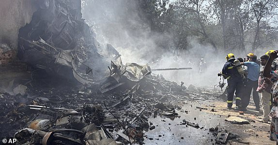 Firefighters work at the site of an airplane that crashed in India's northwestern city of Ahmedabad in Gujarat state, Thursday, June12, 2025. (AP Photo/Ajit Solanki)