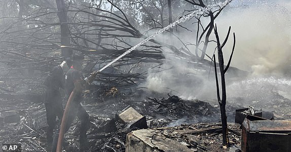 Rescuers work at the site of an airplane that crashed in India's northwestern city of Ahmedabad in Gujarat state, Thursday, June12, 2025. (AP Photo/Ajit Solanki)