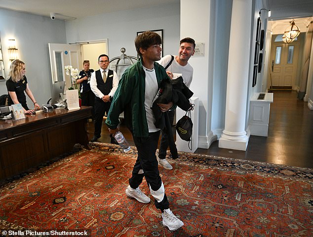 Louis arrived wearing a green sports jacket and black tracksuit bottoms ahead of training with the rest of the team