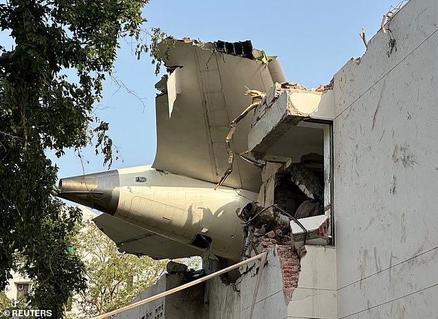The tail of the Dreamliner plane that crashed, hitting buildings in a residential area