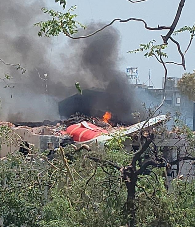 Chunks of the plane's fuselage and tail were seen protruding from a demolished building