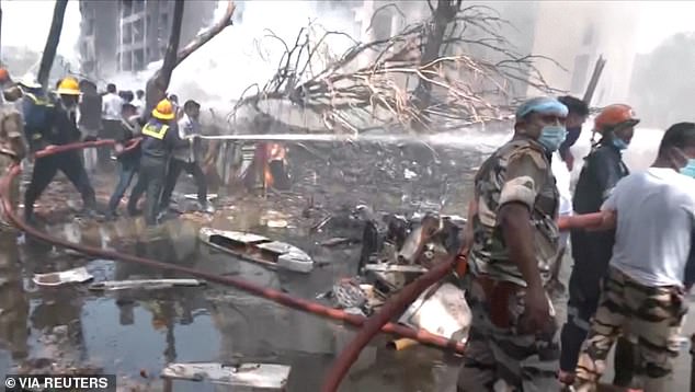 Emergency personnel work at the crash site of an Air India plane in Ahmedabad, India, June 12, 2025