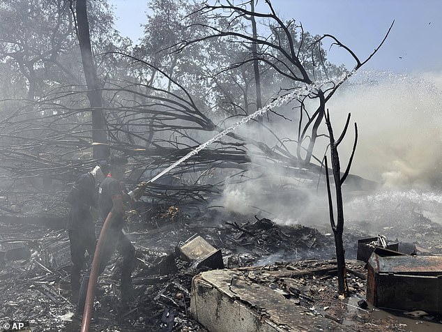Rescuers work at the site of an airplane that crashed in India's northwestern city of Ahmedabad in Gujarat state, Thursday, June12, 2025