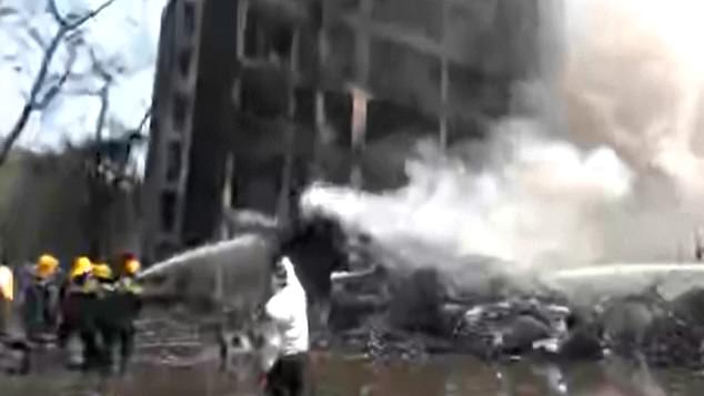 Firefighters at the scene doused the smouldering piles of debris with their hoses as photos and videos taken by horrified residents in Meghani showed a huge plume of thick black smoke emanating from the crash site