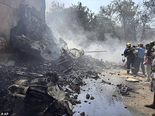 Firefighters work at the site of an airplane that crashed in India's northwestern city of Ahmedabad in Gujarat state, Thursday, June12, 2025