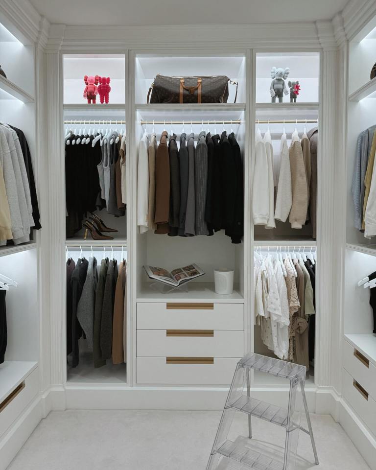 Walk-in closet with clothing and accessories.