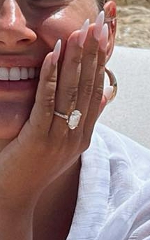 Close-up of a woman's hand showing off an engagement ring.