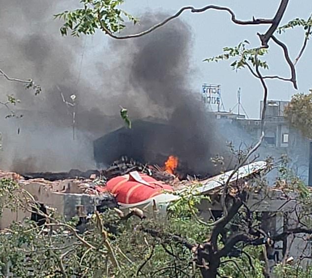 Chunks of the Air India fuselage and tail were seen protruding from a demolished building