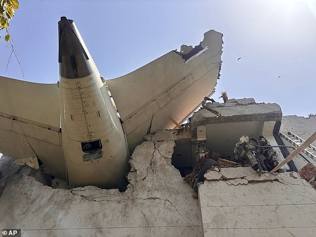 The tail of the jet is seen protruding from a building in the Meghani area of the city