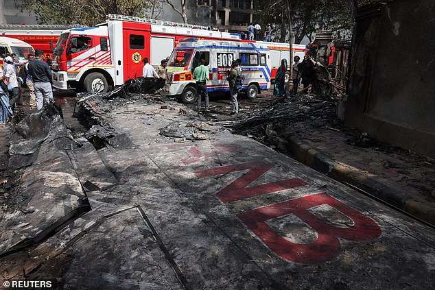 Wreckage of a Boeing 787 Dreamliner lies at the site, showing part of its registration "VT-ANB", where the Air India plane crashed in Ahmedabad, India, June 12, 2025