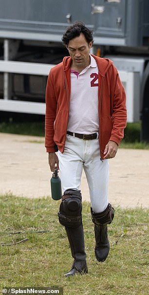 The actor, 44, sported a red hoodie and carried a water bottle as he strolled about the set