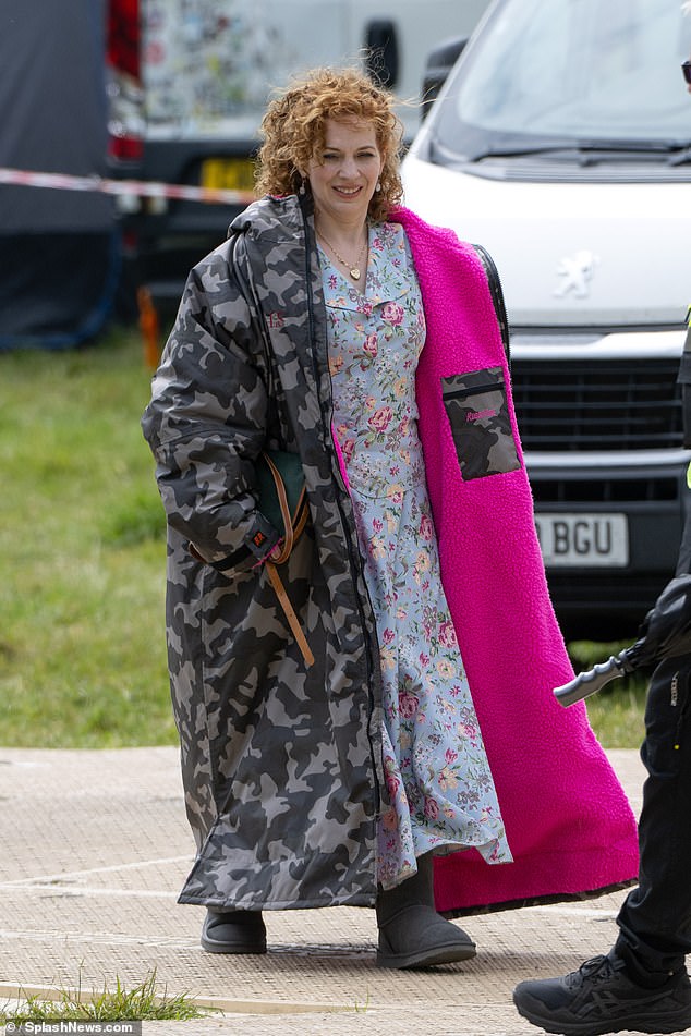 Elsewhere on the set, Katherine Parkinson, 47, donned a floral blue dress beneath a huge pink-lined camouflage coat as she reprised her role as romance novelist Lizzie Vereker