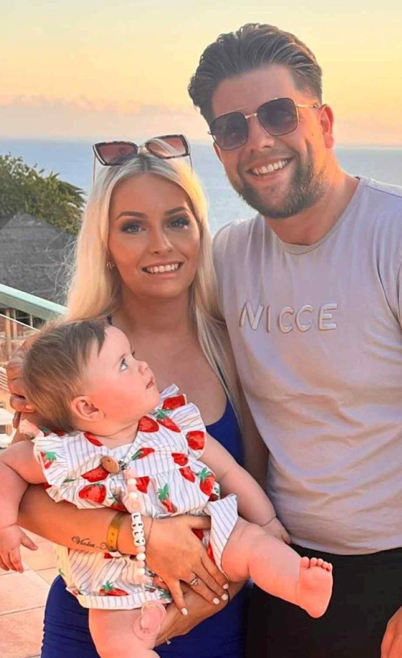 Photo of a mother, father, and baby daughter.
