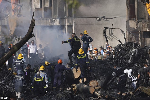 Images of the aftermath of the crash showed parts of the plane embedded into a residential building as firefighters continued to tackle the smoke