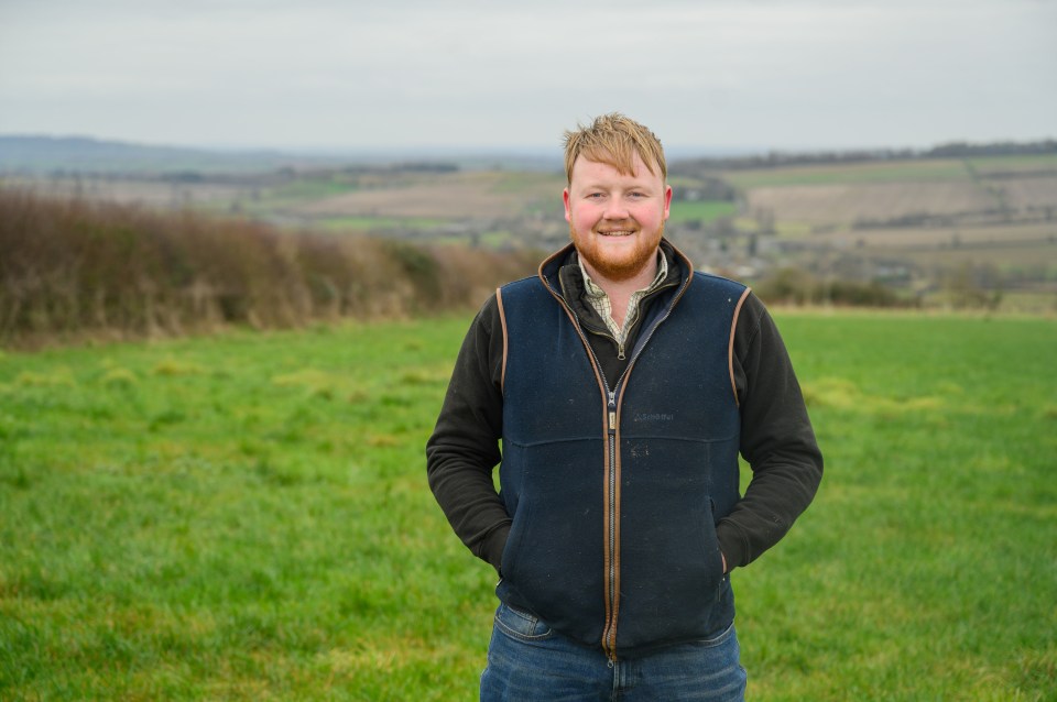 Portrait of Kaleb Cooper standing in a field.