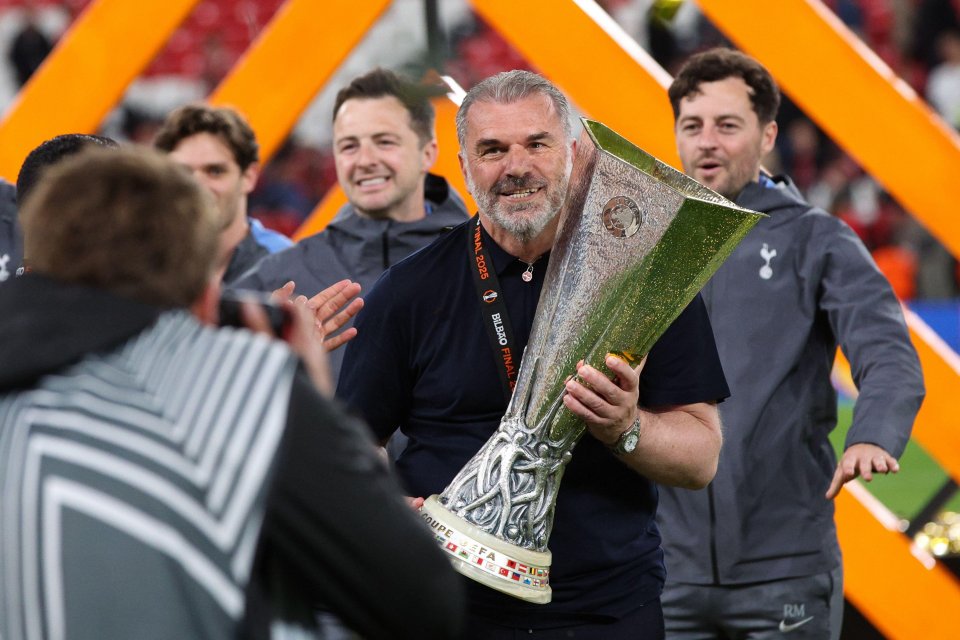 Ange Postecoglou holding the UEFA Europa League trophy.