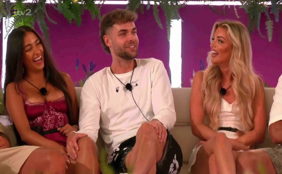 Love Island contestants Shakira, Harry, and Helena playing a game.