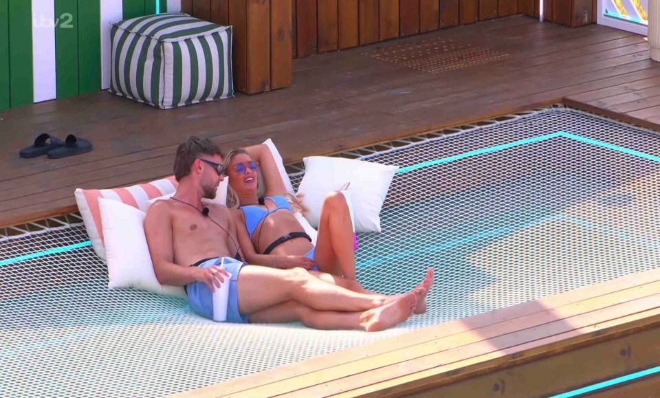 Couple relaxing on a hammock.