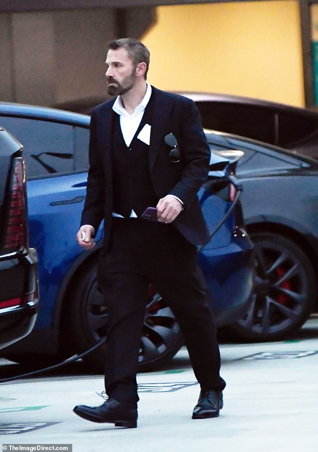 Affleck sported a black jacket, vest, and trousers
