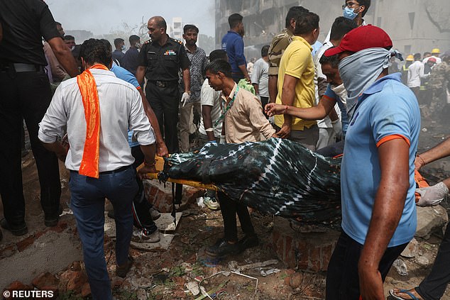 People carry a body away from the crash site