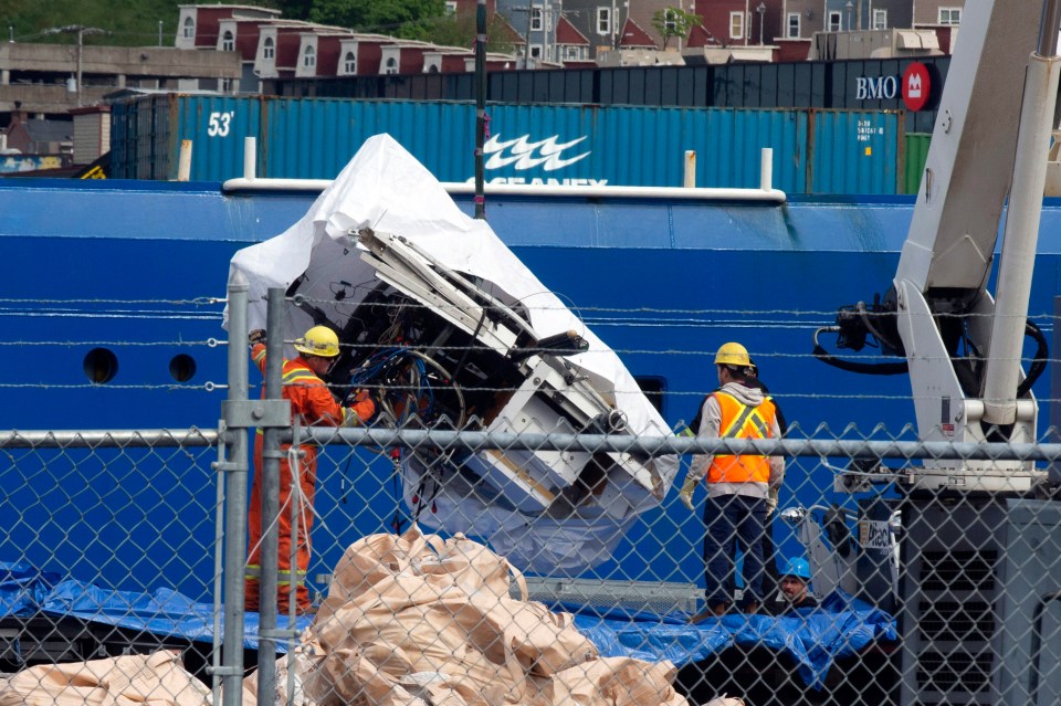 Debris from the Titan submersible being unloaded from a ship.