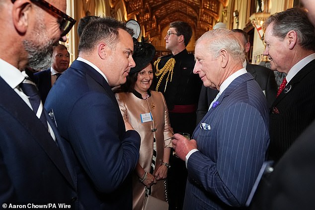 Charles was dapper in a pin-strip suit as he jovially spoke with guests at the reception this evening