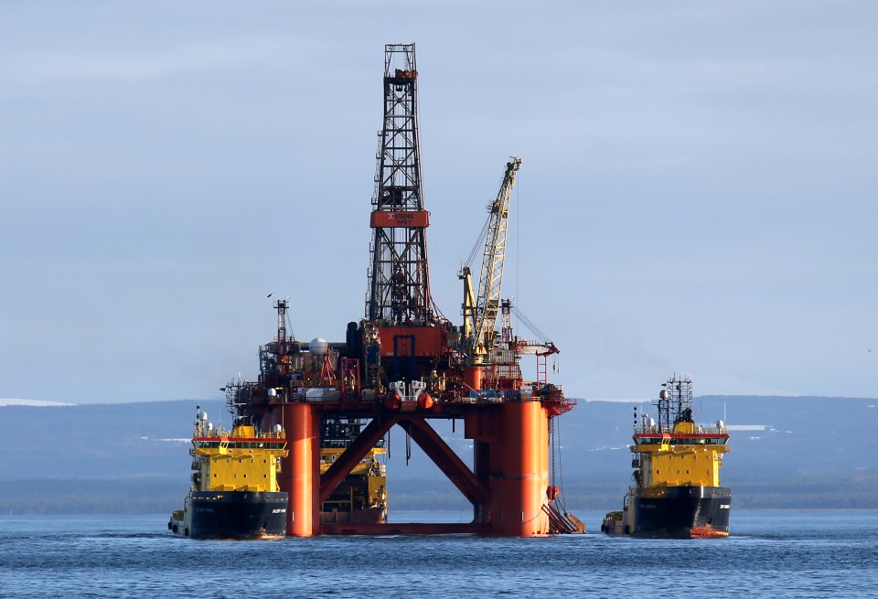 Oil platform Stena Spey being moved by tugboats.