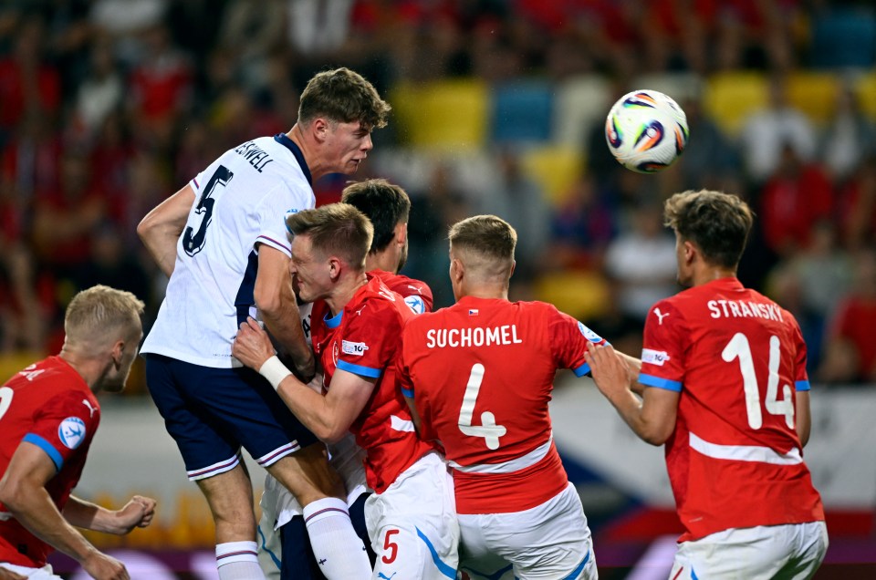 Soccer players vying for a ball.