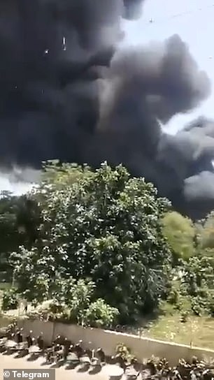 Thick plumes of black smoke are seen rising from the site of the crash