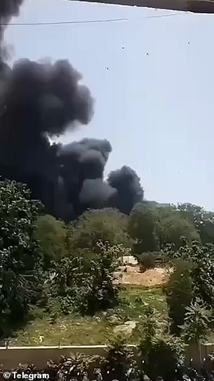 Thick plumes of black smoke are seen rising from the site of the crash