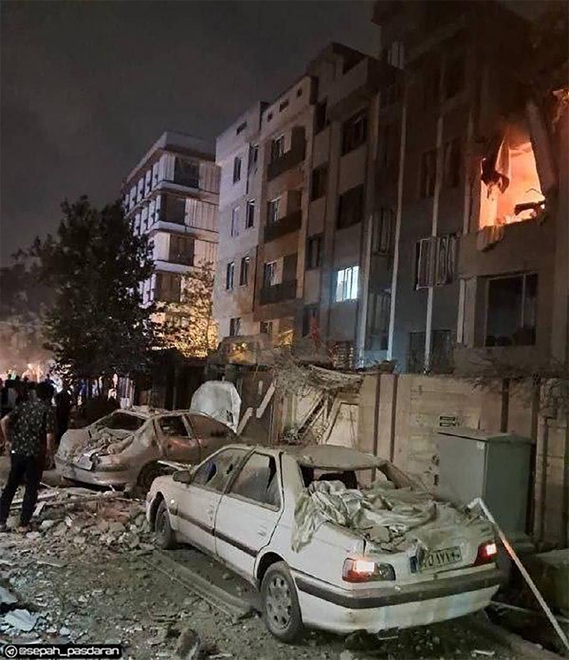 Damage to a Tehran building and cars following an Israeli strike.