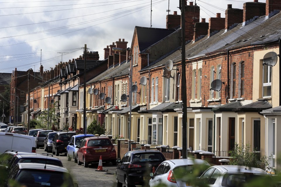 Row of terraced houses with satellite dishes.