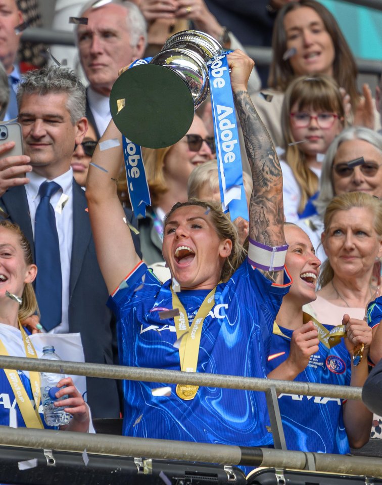 Captain Millie Bright lifts the FA Cup trophy at Wembley Stadium.