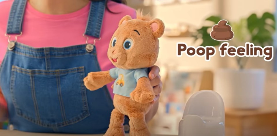 Person holding a brown stuffed bear; text overlay says "Poop feeling".