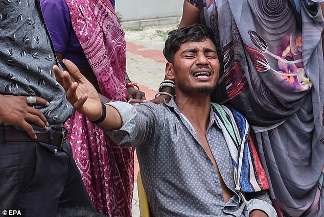 A relative of a victim of the Air India plane crash is comforted