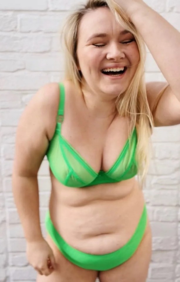 Woman in green lingerie laughing.