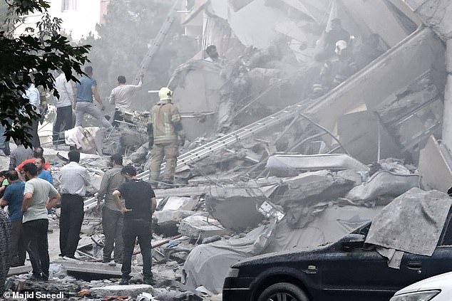 Rescue teams work at damaged buildings in Nobonyad Square following Israeli airstrikes on June 13, 2025 in Tehran, Iran