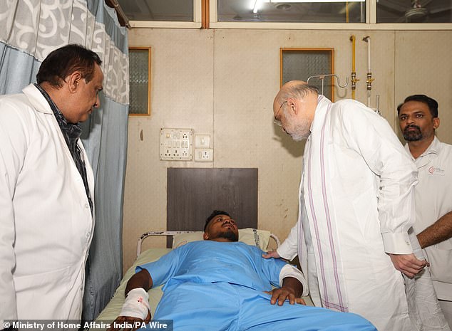 The survivor - who sat in seat 11A - hobbled away after the Air India flight crashed shortly after taking off (seen at a hospital in Ahmedabad meeting India's Home Affairs Minister Amit Shah)
