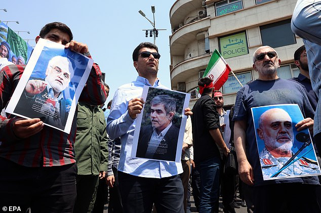 Iranians hold posters of nuclear scientists Mohammad Mehdi Tehranchi (L), Fereidun Abbasi (C) and, IRGC general Gholam Ali Rashid (R) who were killed in Israeli airstrikes during a protest in Tehran