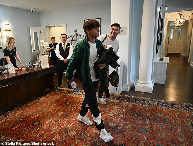 Louis arrived wearing a green sports jacket and black tracksuit bottoms ahead of training with the rest of the team