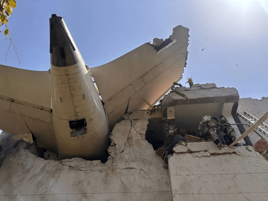Plane wreckage embedded in a building.