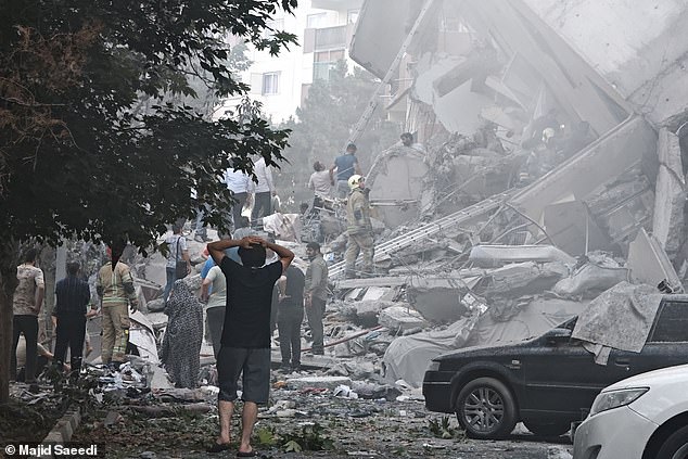People look over damage to buildings in Nobonyad Square following Israeli airstrikes on June 13, 2025 in Tehran, Iran