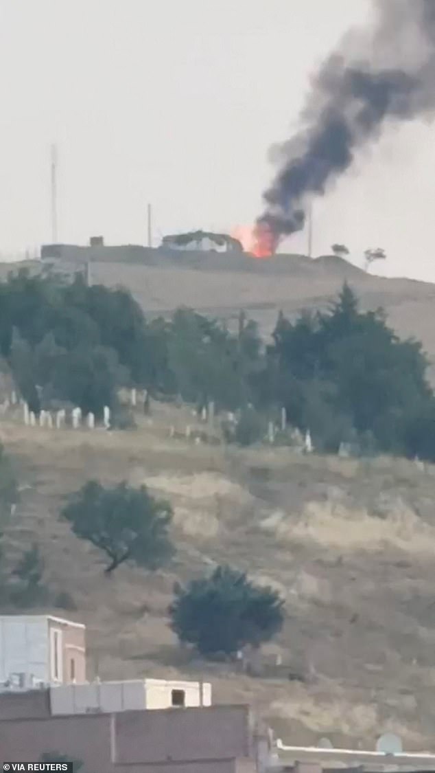 Smoke and flames rise, following Israeli strikes on Iran, in Piranshahrm, on June 13, 2025