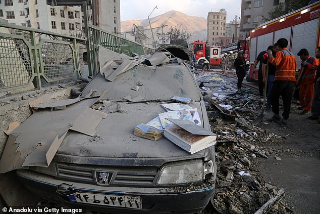 Debris on cars in the Iranian capital of Tehran after the overnight strikes, on June 13