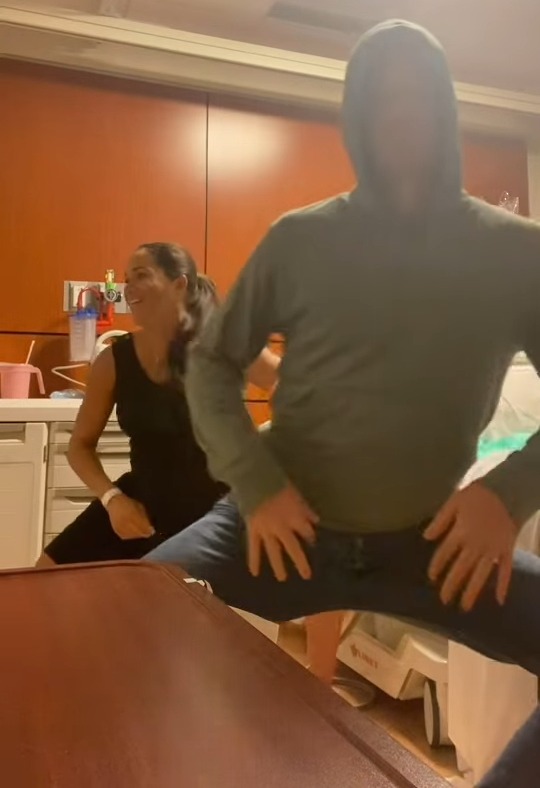 Meghan Markle and Prince Harry dancing in a hospital room.