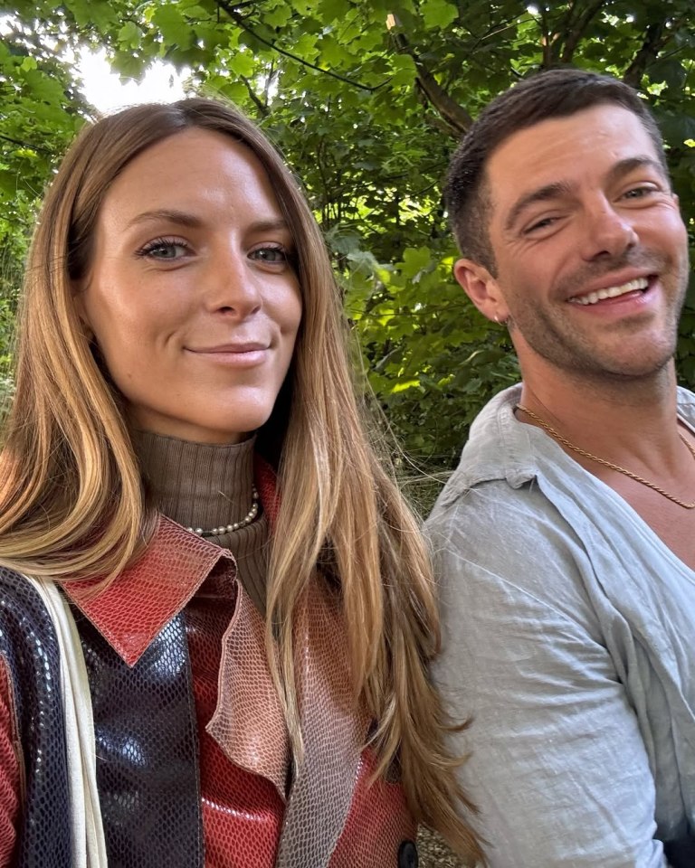Alex Mytton and a woman stand shoulder-to-shoulder, outdoors.