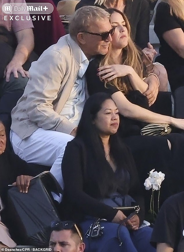 Kevin relocated to sit beside Lily, where he greeted her with a warm hug