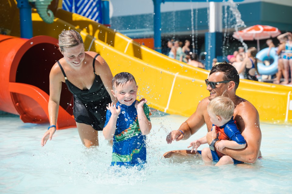 Family playing in a water park.