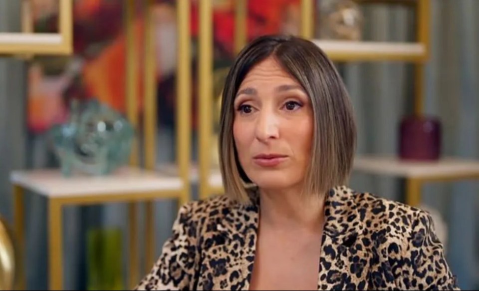 Woman in leopard-print jacket reacting to news.