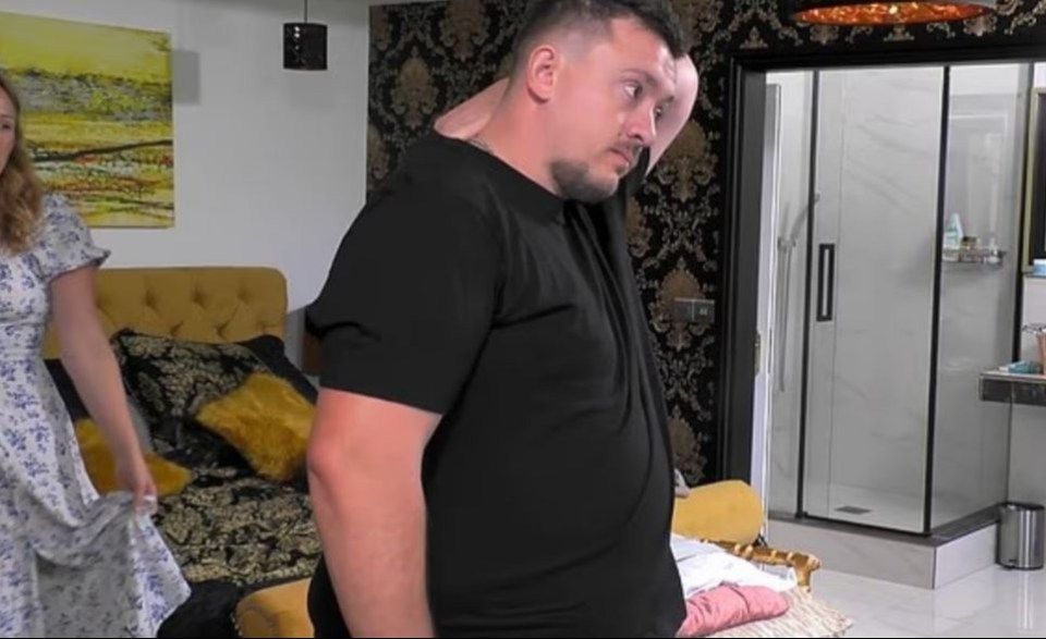 Man reacting to news in a bedroom.